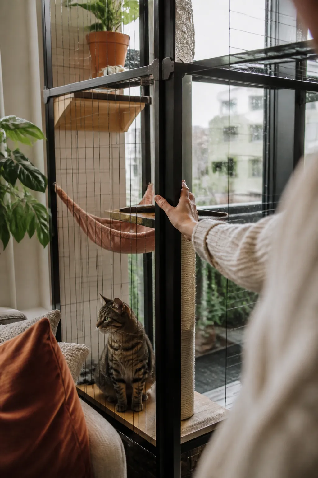 Hand pressing on a catio panel connector joint to check it for looseness after a storm.